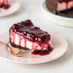 Creamy no-bake cheesecake topped with glossy cherry topping and fresh cherries